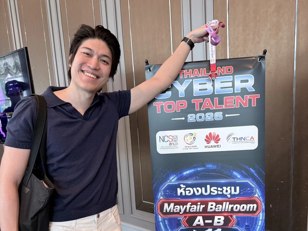 Ohm holds up the medal beside the Thailand Cyber Top Talent 2026 banner.